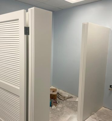 Interior door with louvered panels installed in a residential space.